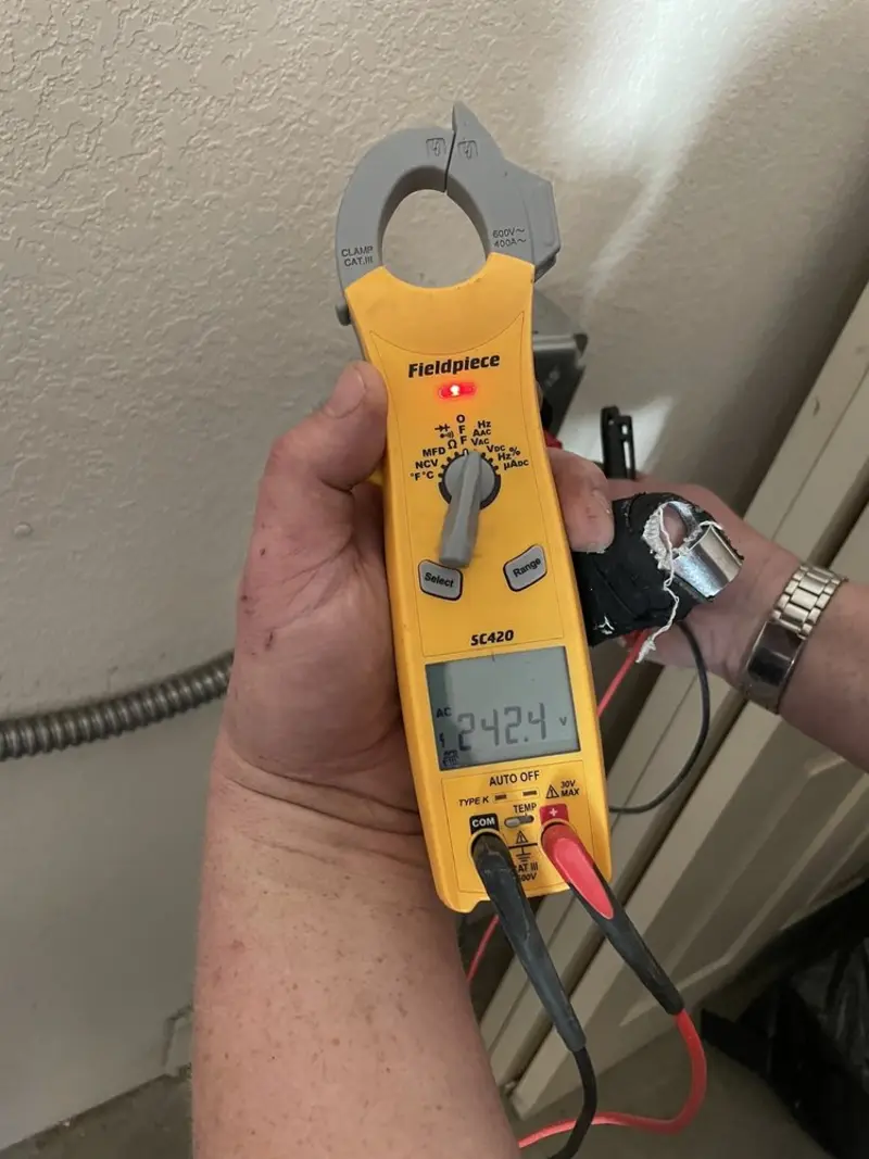 Voltage testing with clamp meter during Ceiling Fan Installation in Seabrook